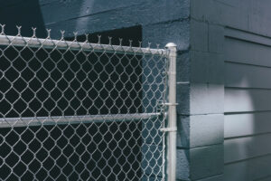 Chain-link,Fence,Over,Building,Doorway,,Graffiti,Spray,Paint,On,Urban
